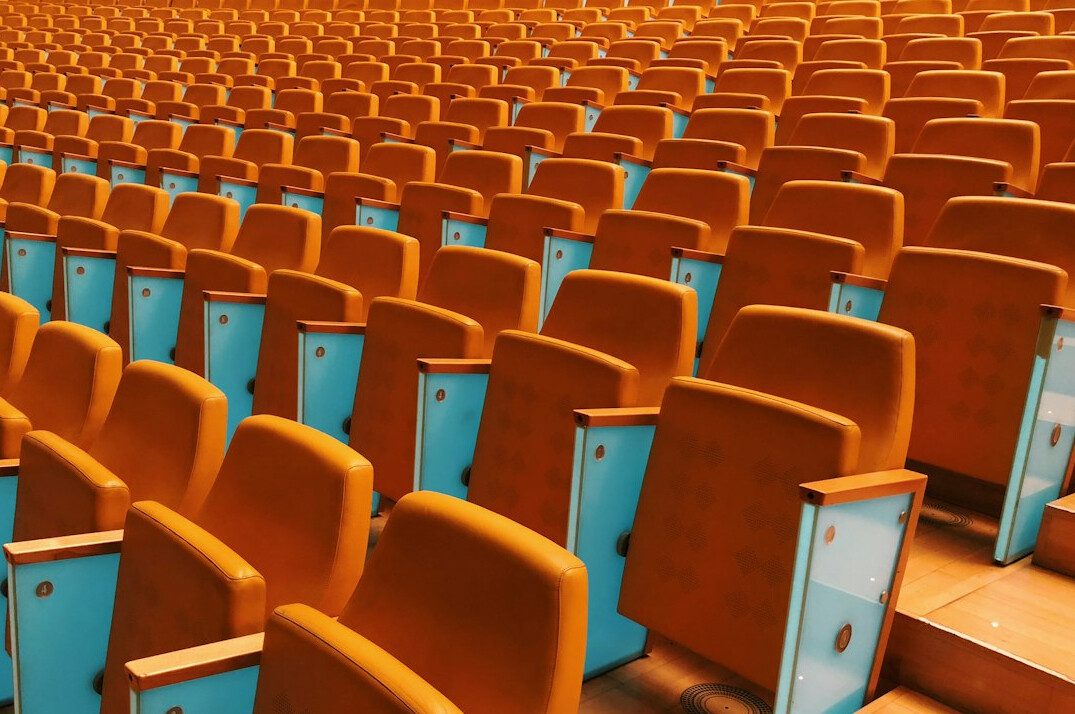 Rows of empty seats in a theatre before an event