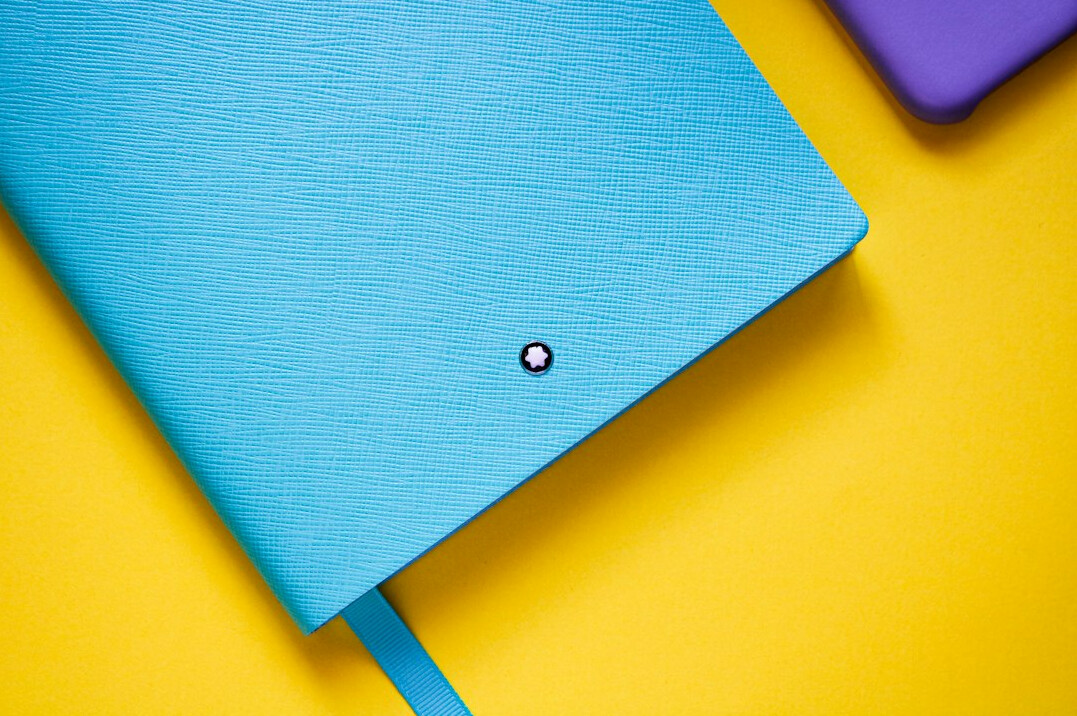Press accreditation badge resting on a notebook