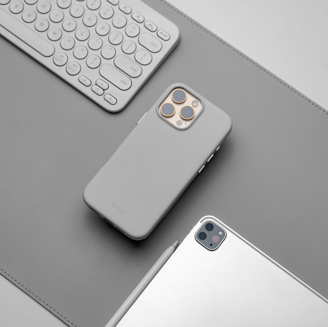 Open notebook and pen beside a telephone on a wooden desk