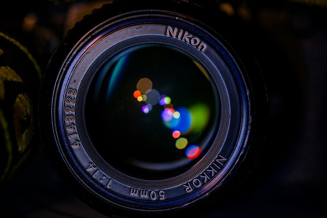 Camera lens close up with lights reflected in the glass