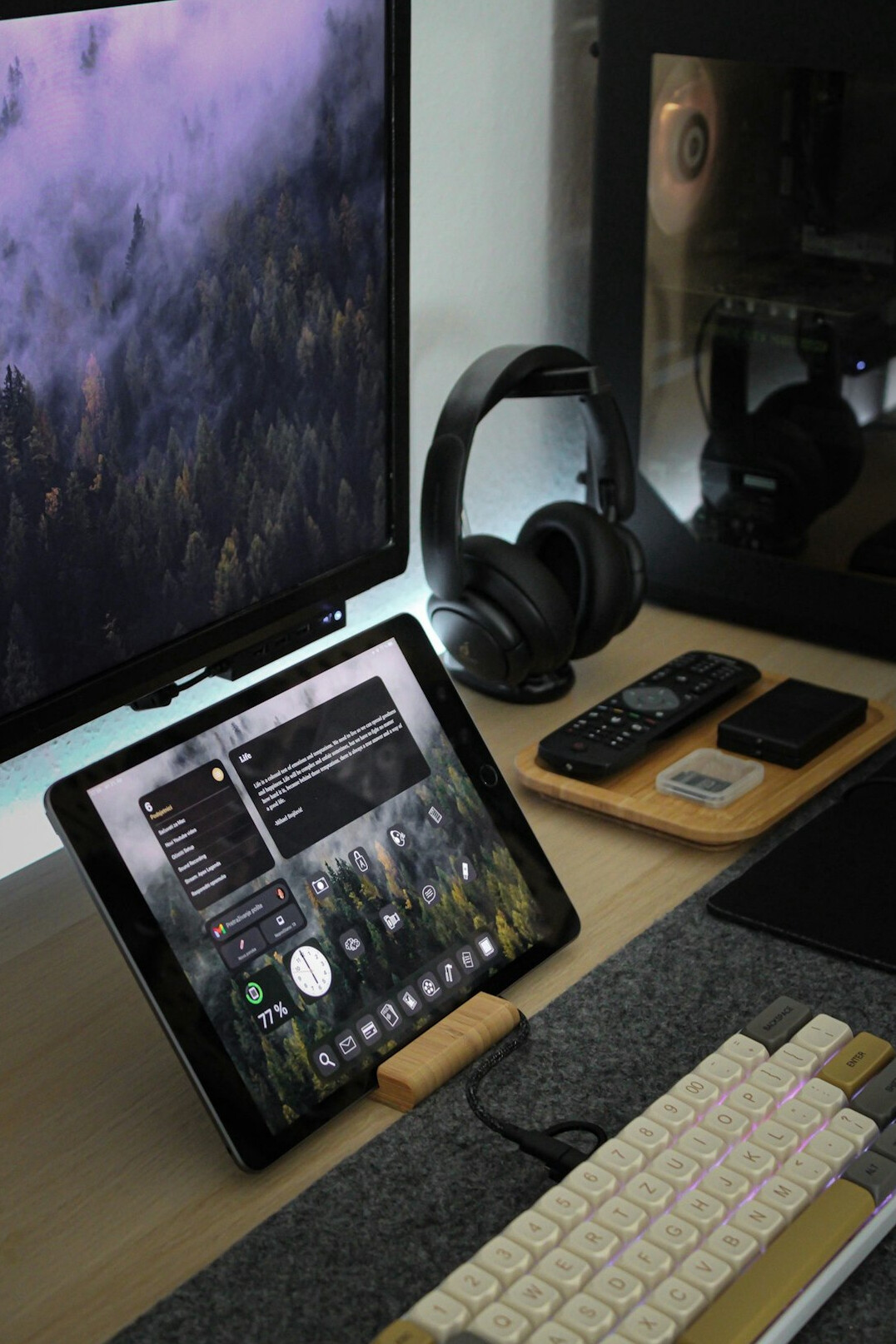 Designer reviewing a magazine layout on a tablet and desktop monitor