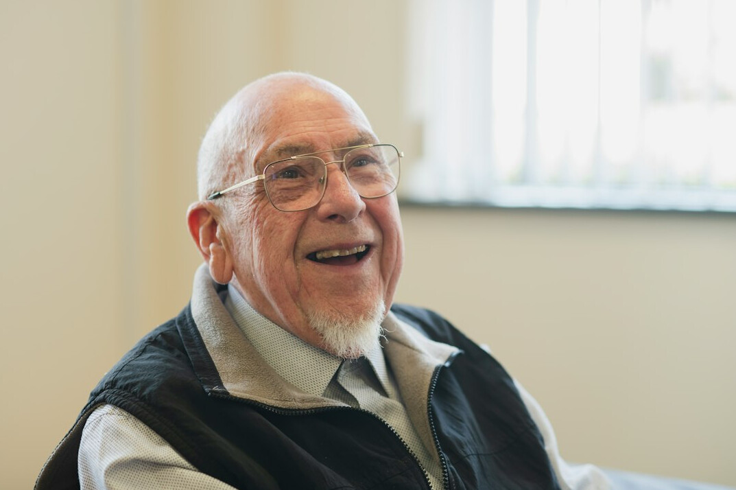 elderly man smiling at event