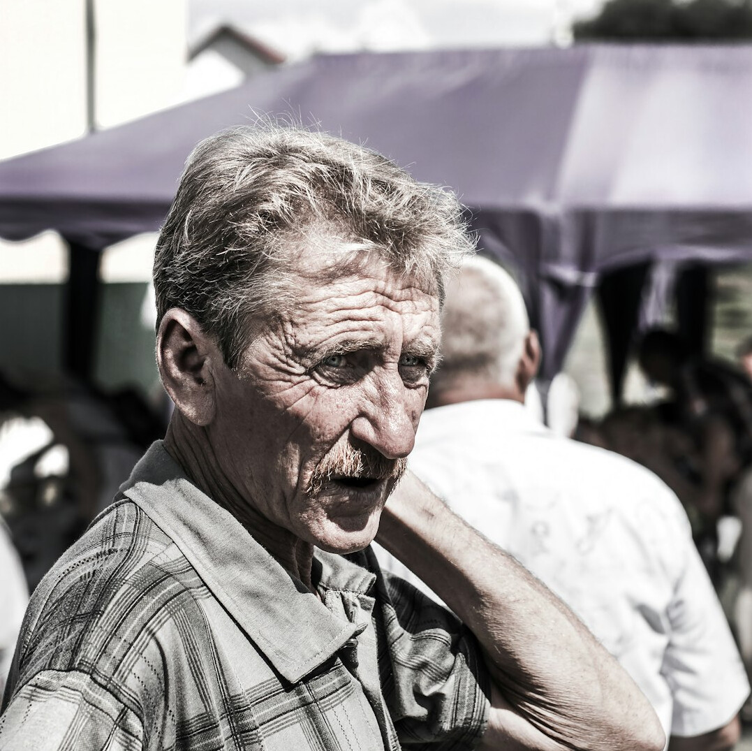 elderly man smiling at event