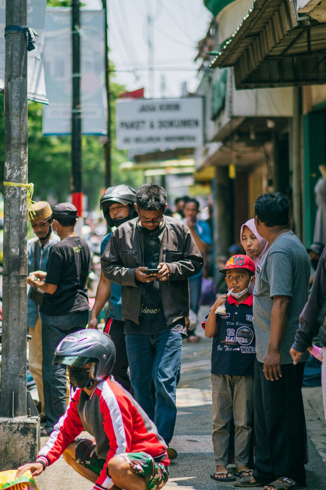 group of people chatting in street