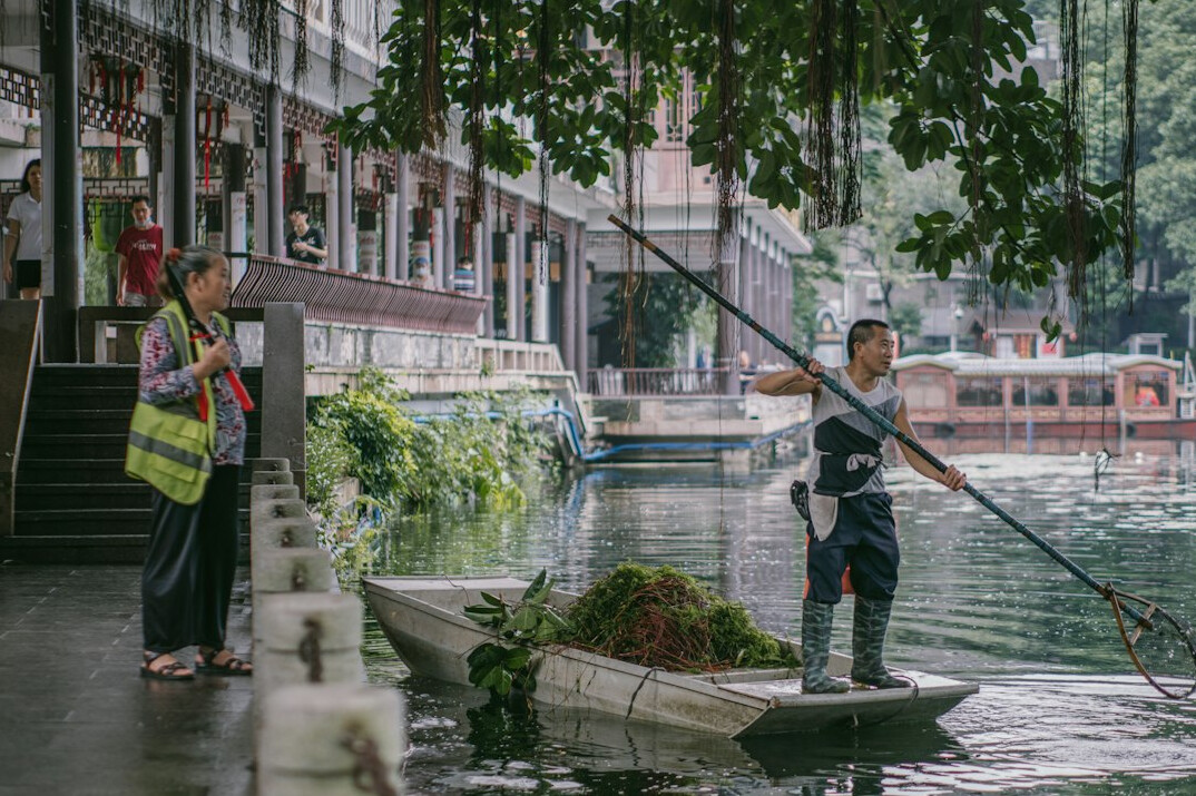 people cleaning river bank